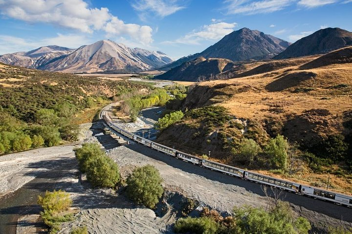 Journey through stunning landscapes as the TranzAlpine train weaves past majestic mountains and lush valleys revealing the beauty of New Zealand's South Island at every turn. Perfect for explorers.